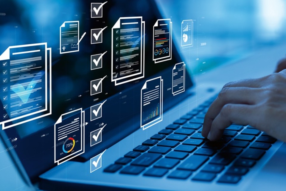 Laptop, toetsenbord, documenten op beeldscherm