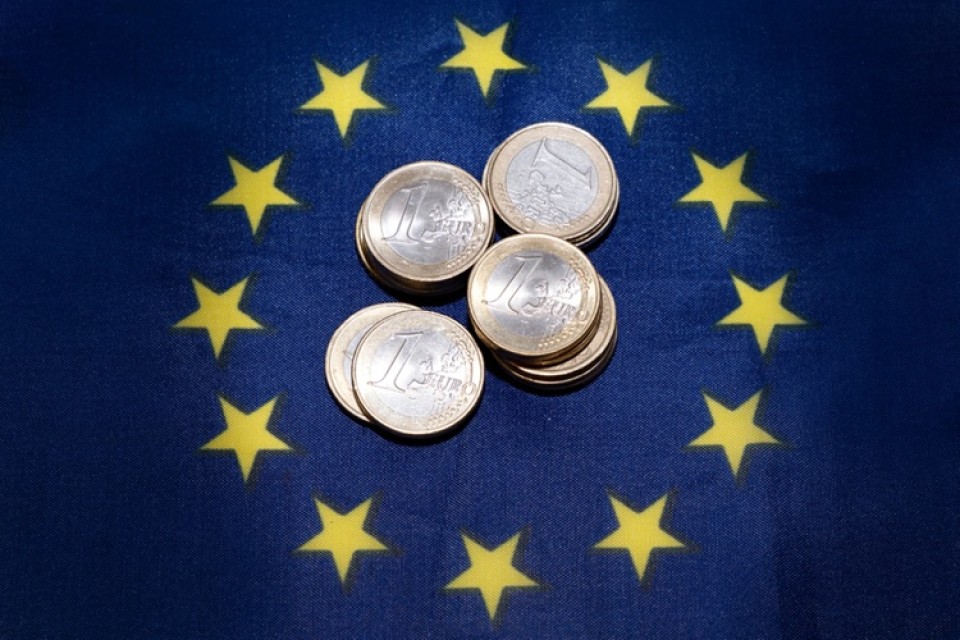 Small,Stacks,Of,Euro,Coins,On,Eu,Flag,,Budget,,Grant