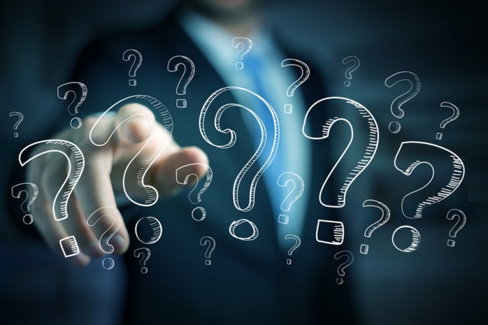 Businessman,On,Blurred,Background,Touching,Hand,Drawn,Question,Marks,With|||